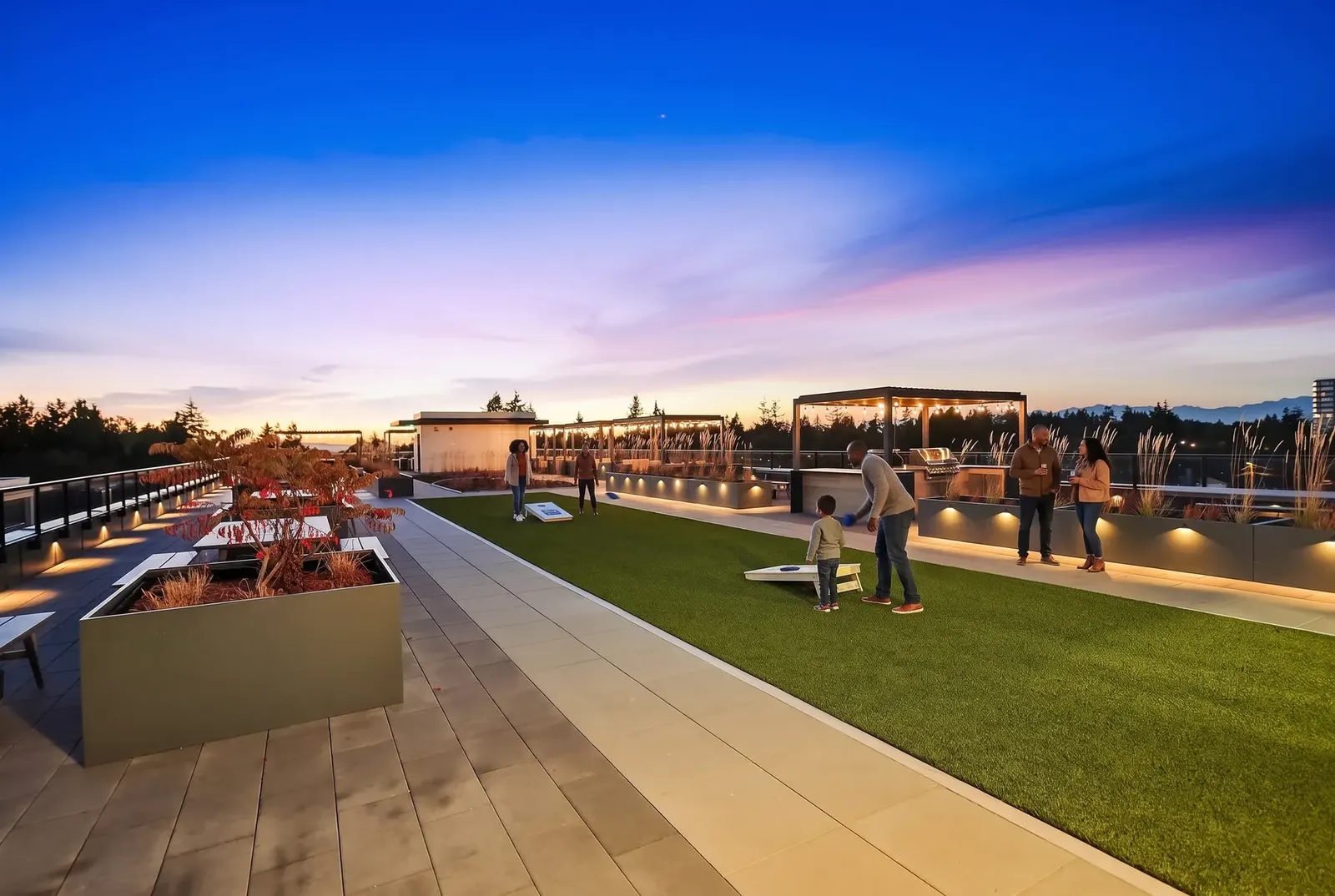 Families and neighbours enjoying rooftop games at sunset at Scott + 77, North Delta