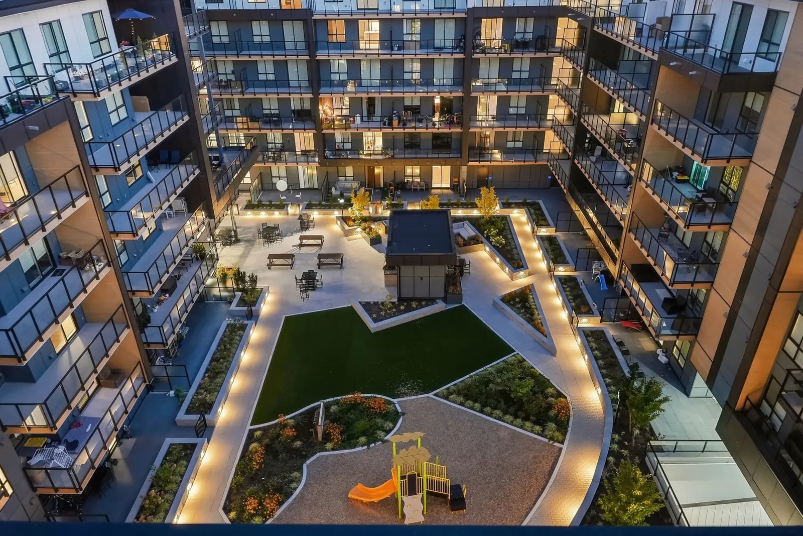 Landscaped Scott + 77 courtyard at dusk, North Delta